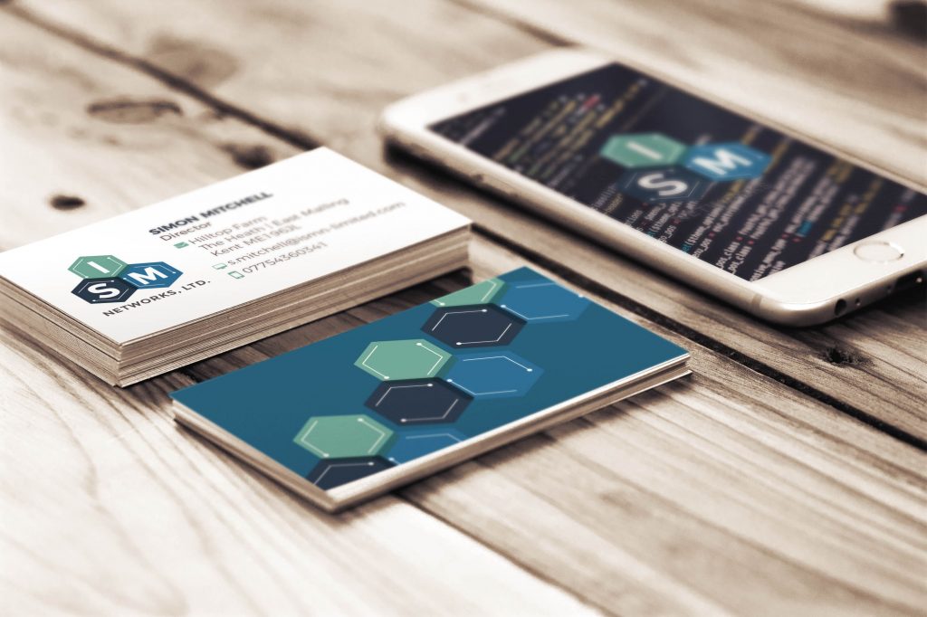 modern and geometric logo design shown on business cards and iPhone for ISM Networks, LTD.