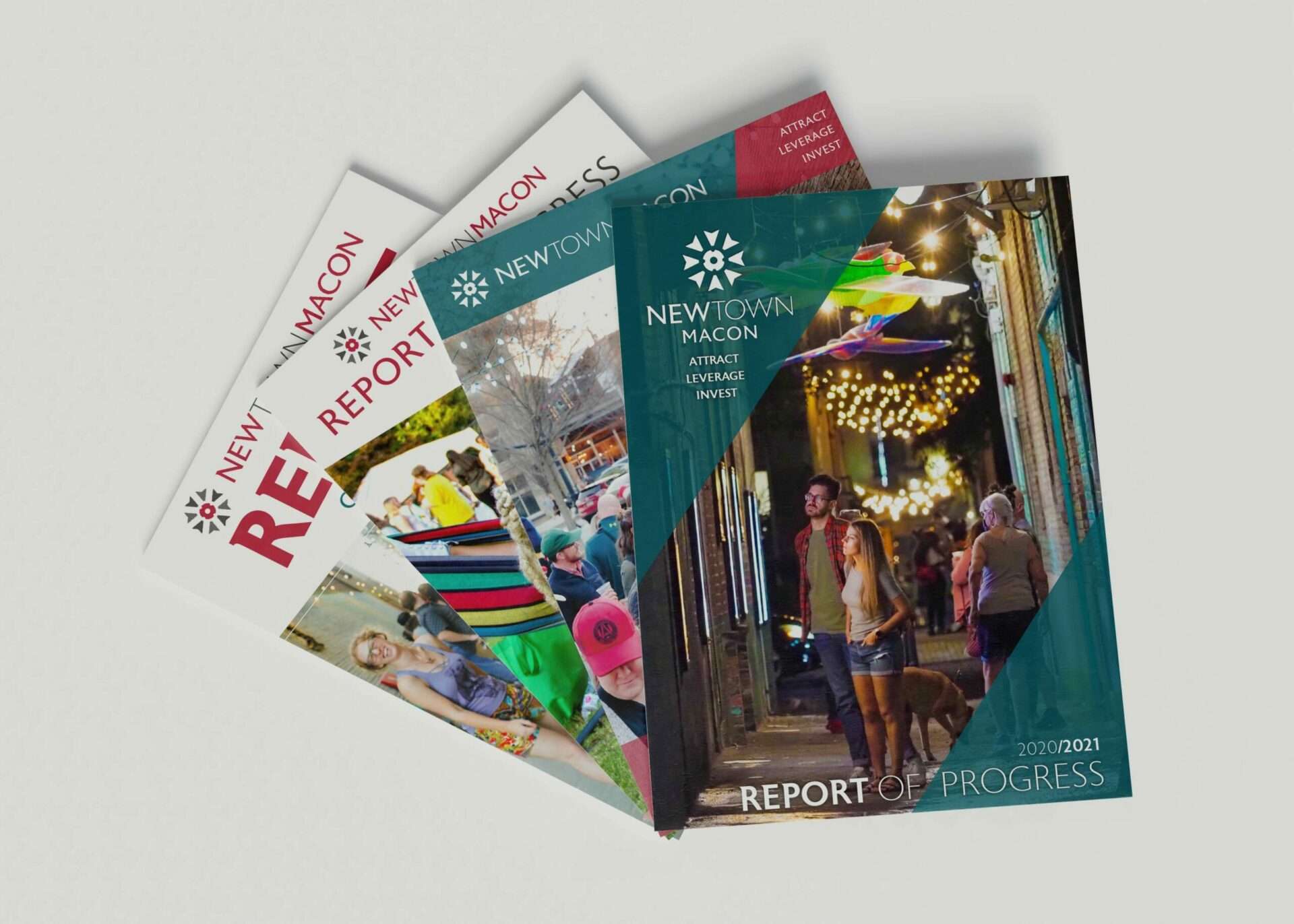 stack of 4 colorful and bold annual reports for Newtown Macon on an isolated white background