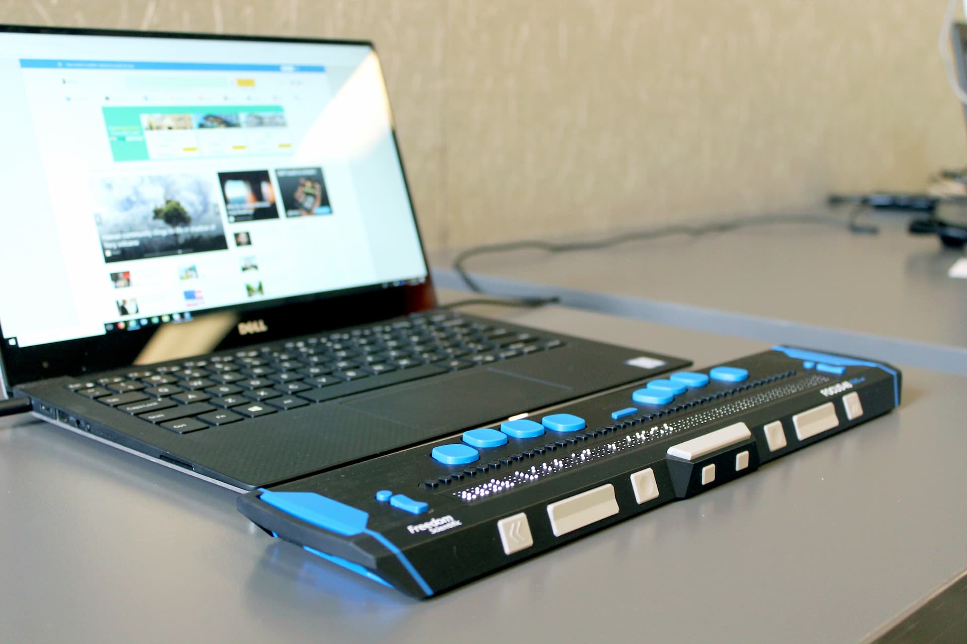 A laptop computer with an adaptive keyboard attached for low vision or no vision users